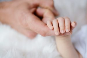 baby holding it s parent finger